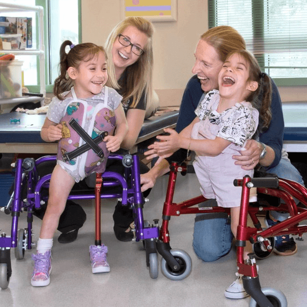 Formerly conjoined young girl Shriners patients laugh in hospital