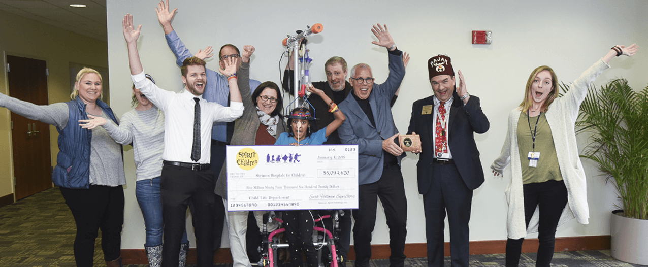 Shriners corporate partner Spirit Halloween poses with oversized check